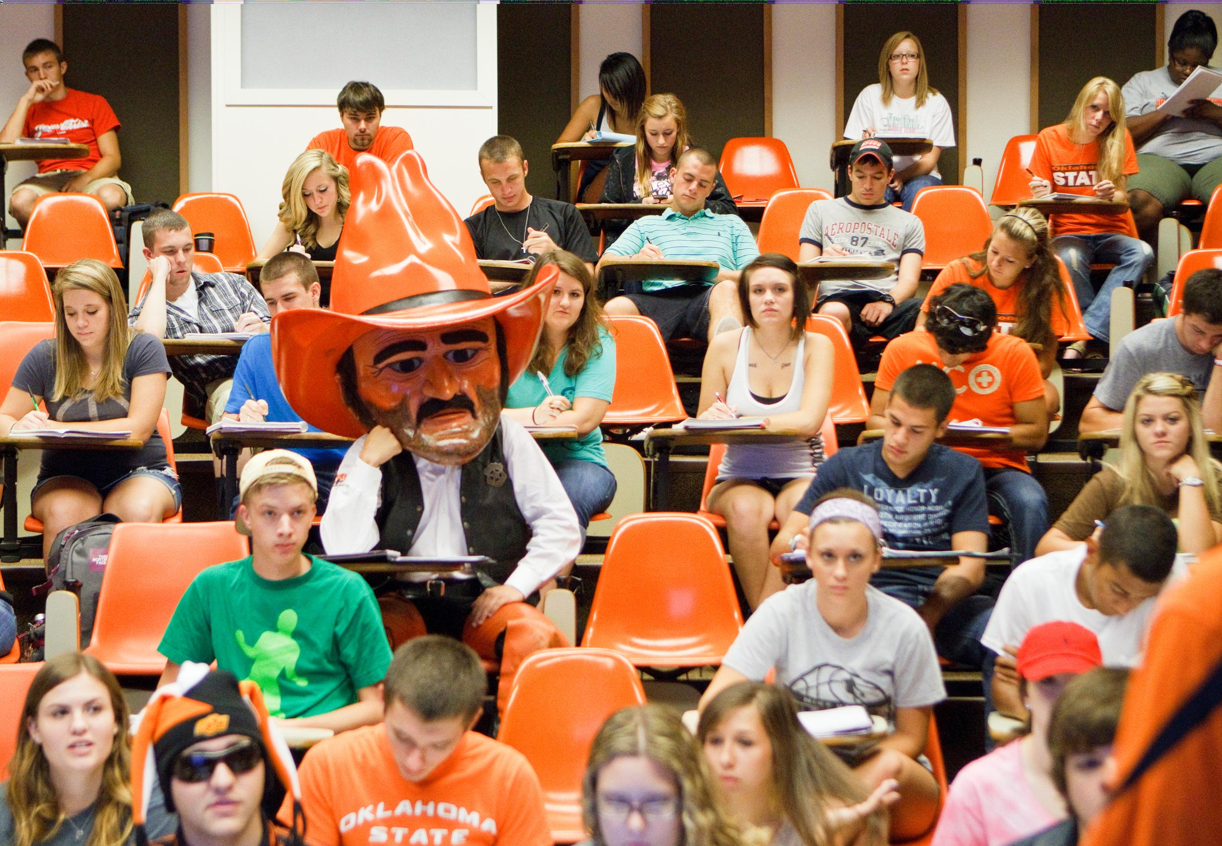 A classroom full of students, including Pistol Pete, who is resting his hand on his chin while listening