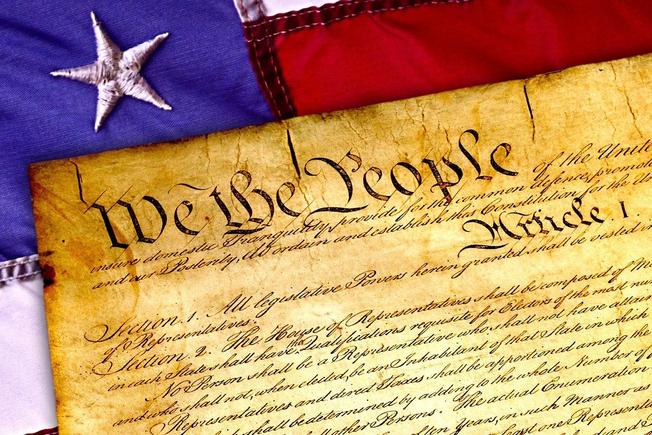 The preamble to the United States Constitution with United States flag in the background