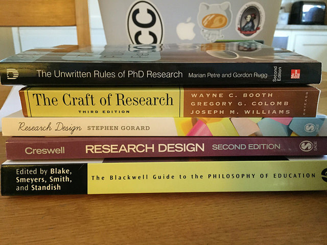 A pile of books about research
