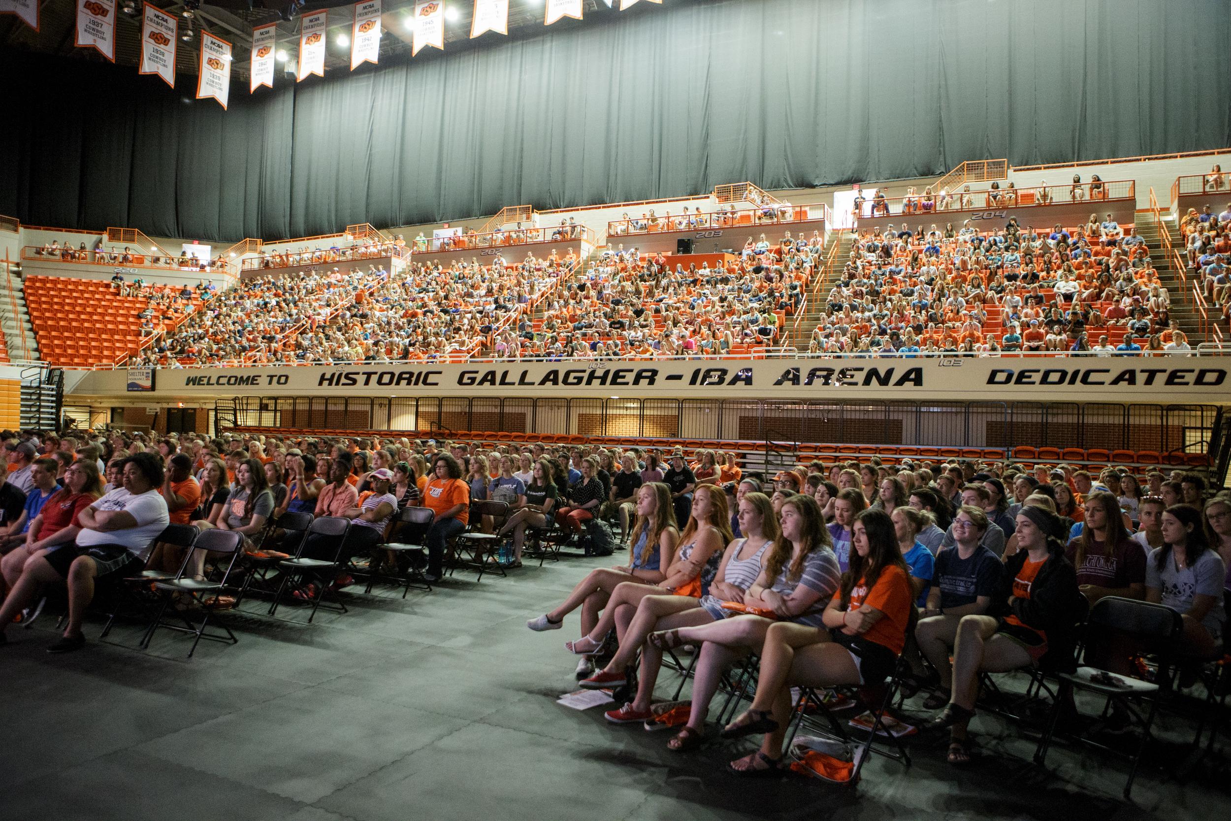 Oklahoma State University's basketball stadium, Gallagher Iba Arena filled with students who are listening to a speaker