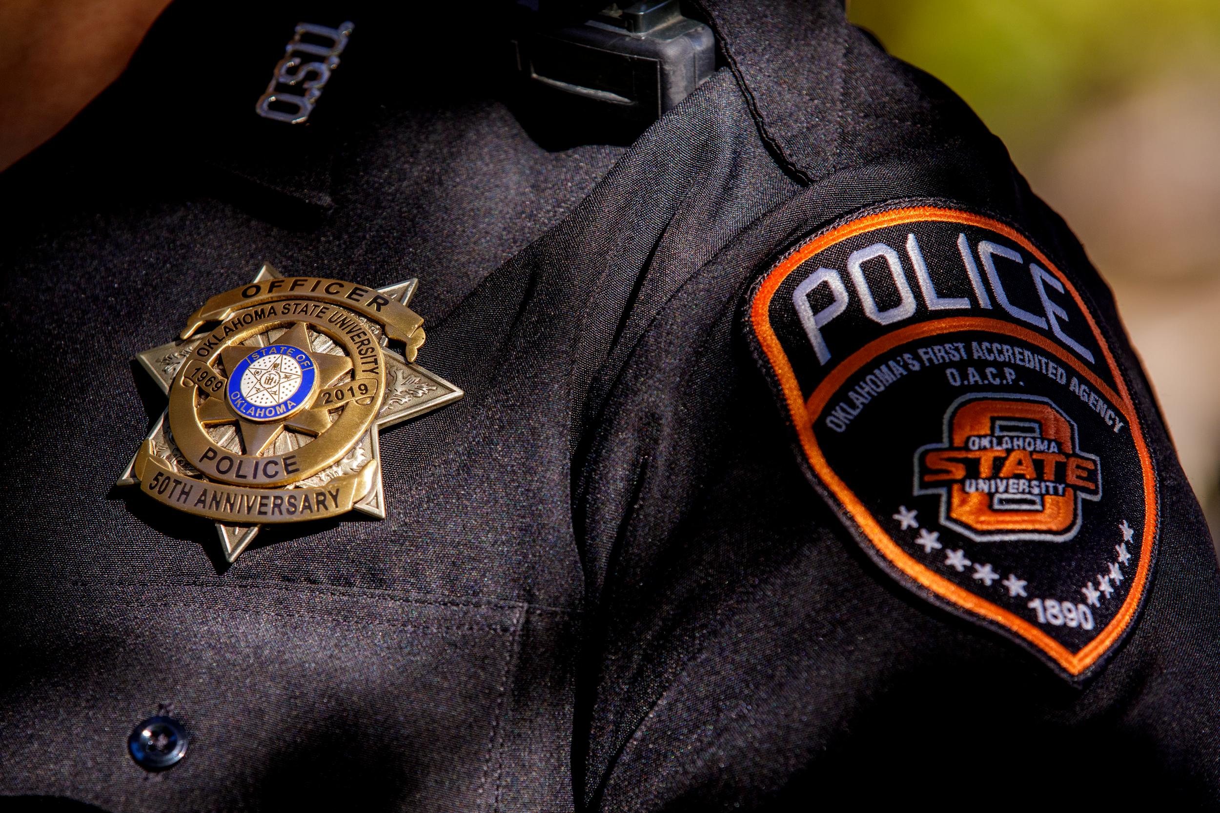 A zoomed in picture of an OSU police officer's badge and police patch