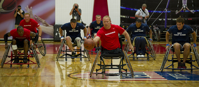 A group of individuals in wheelchairs playing basketball together
