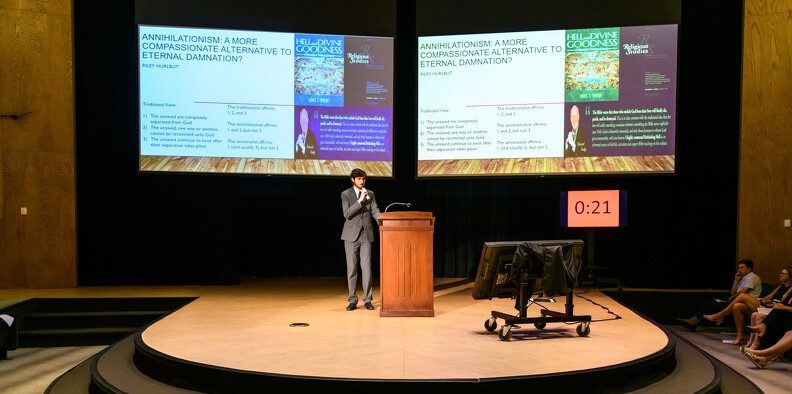 A man gives a presentation using slides as presentation aids.